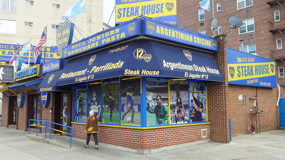 A blue and deep yellow facade with steak house and parrillada written all over it.