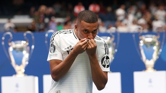 Kylian Mbappe kisses his jersey during his first appearance as a Real Madrid player at the Santiago Bernabeu Stadium in Madrid (AFP)