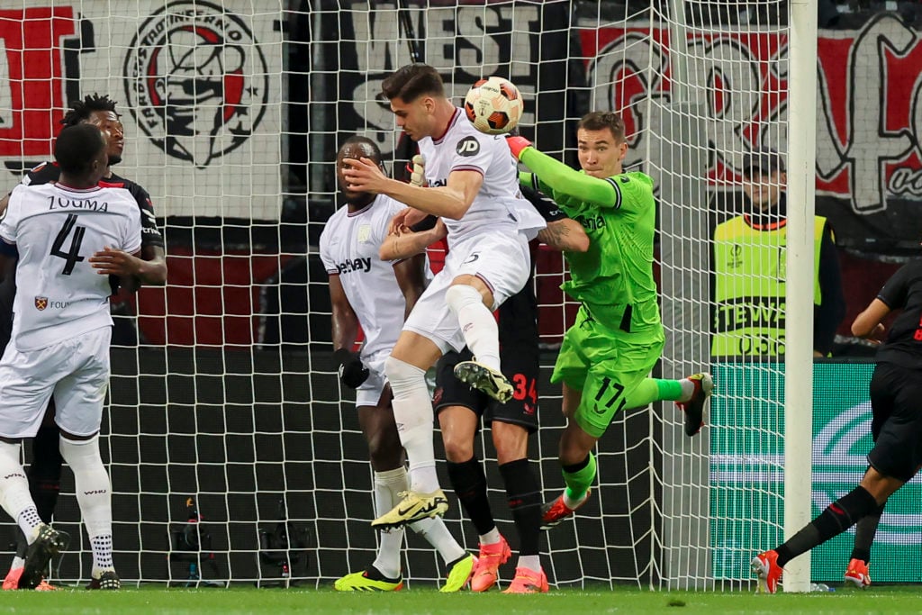 Konstantinos Mavropanos of West Ham United, Granit Xhaka of Bayer 04 Leverkusen and Goalkeeper Matey Kovar of Bayer 04 Leverkusen battle for the ba...