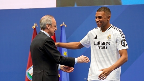 Real Madrid president Florentino Perez embraces Kylian Mbappe, of France, during his presentation to fans as a new Real Madrid player at the Santiago Bernabeu (AP)